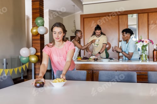 Preview: Friends preparing snacks and drinks in kitchen, enjoying casual gathering at home