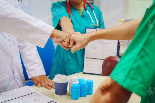 Preview: Three doctors join hands at a hospital table after meeting on liver disease,discussing conditions