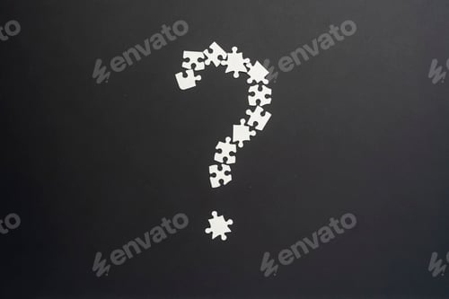 Preview: closeup puzze question mark on dark background isolated b