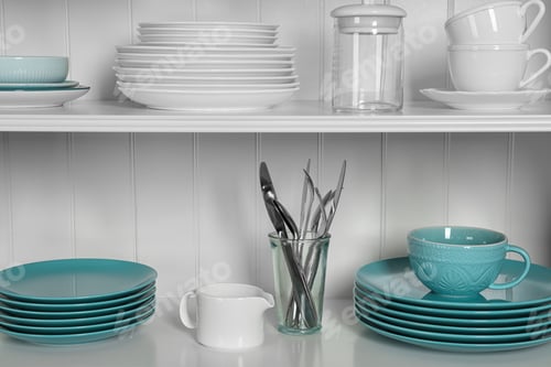 Preview: White shelving unit with set of dishware