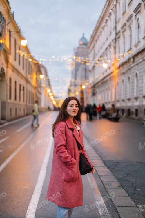 Preview: Woman while on a walk in the city during Christmas holidays.