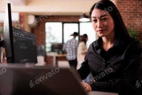 Preview: Asian freelance coder analyzing compiling html code