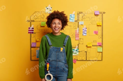 Preview: Happy African American architect woman works on house renovation, has creative occupation, stands wi