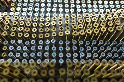 Preview: gold and silver nails hanging neatly on a building shop window