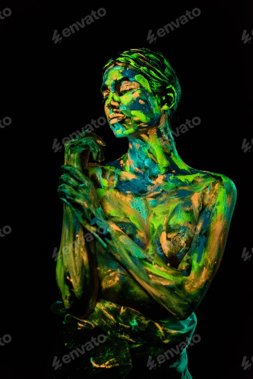 Preview: portrait of woman painted with bright neon paints on black backdrop