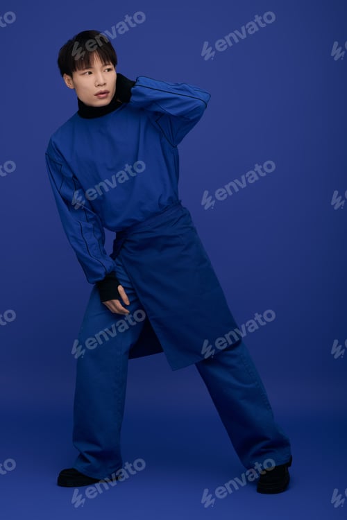 Preview: Captivating young asian man in stylish blue attire poses with confidence and charm