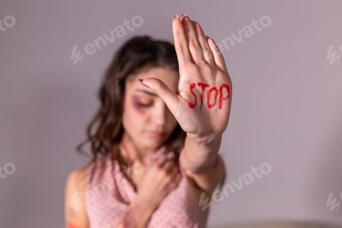 Preview: Domestic violence, protesting and people concept - brunette woman expressing denial with STOP on her