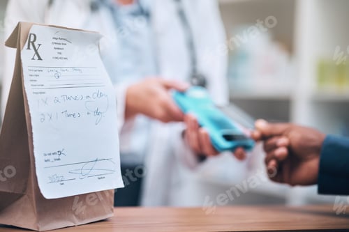 Preview: Pharmacy, card machine and patient paying for the medication at medical clinic dispensary. Credit c