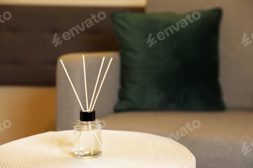 Preview: Aromatic reed air freshener on table indoors, space for text