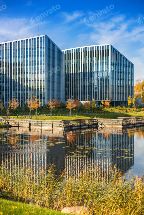 Preview: A striking modern building with a reflective facade sits beside a water feature