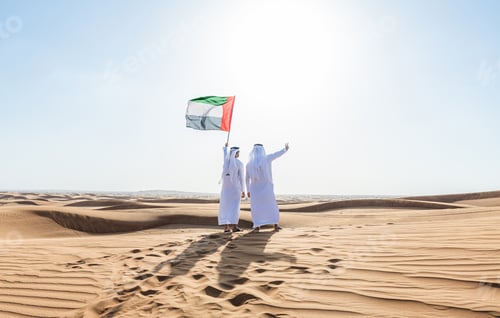 Preview: Two middle-eastern emirati men wearing arab kandura bonding in the desert