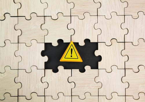 Preview: wooden puzzle with caution sign. careful concept