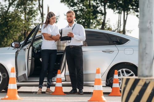 Preview: Standing by the car, the results of drive. Woman is trying to pass exam in the driving school