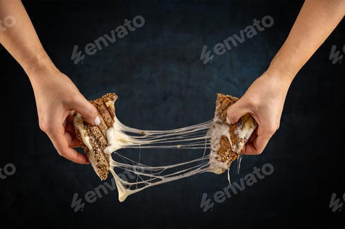 Preview: Two hands pulling apart a grilled cheese