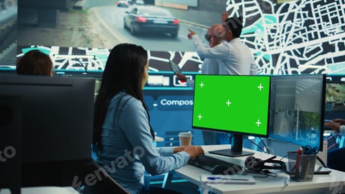 Preview: Indian employee follows order shipment next to a greenscreen on pc