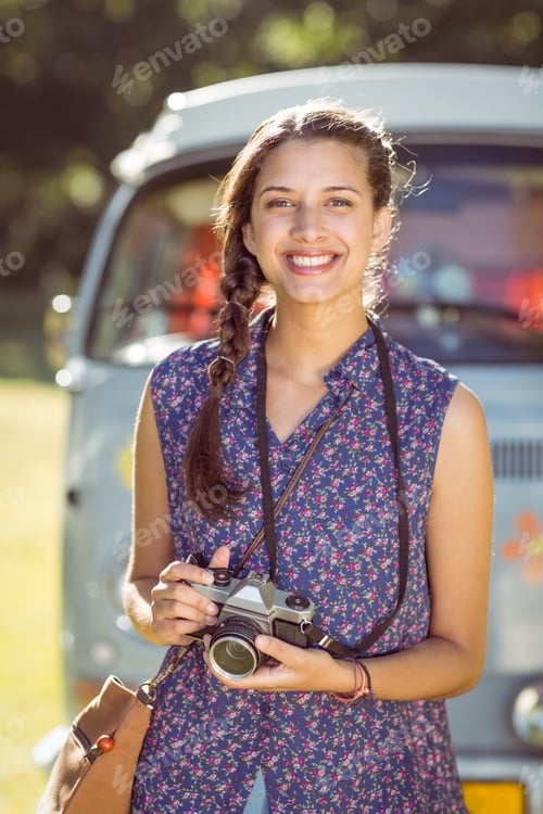 Preview: Pretty hipster taking a photo on a summers day
