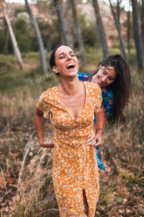 Preview: Two young women walking through the forest wearing dresses