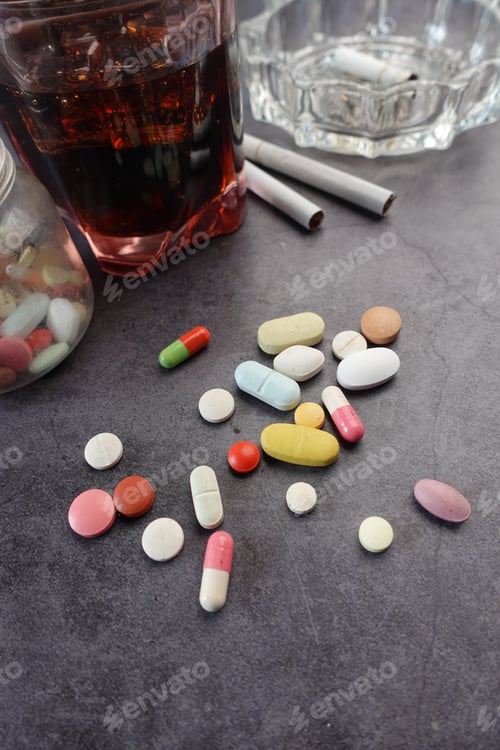 Preview: alcohol, pills and cigarette on table