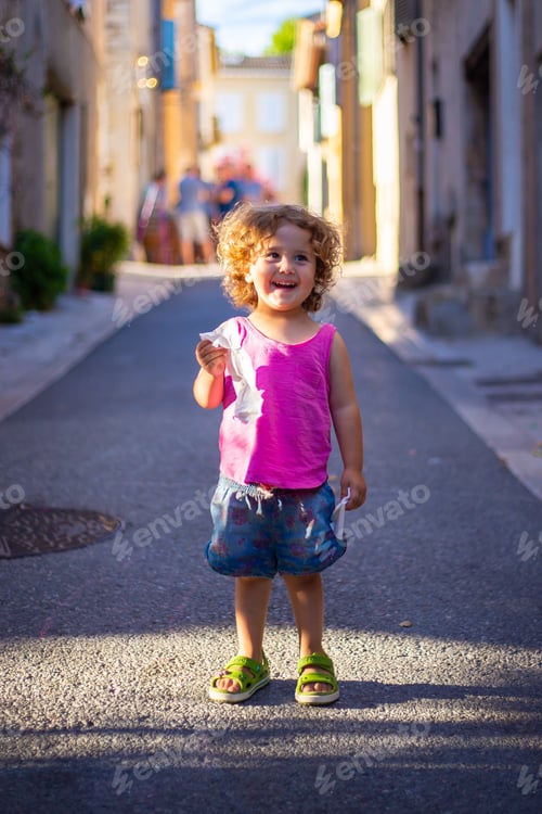 Preview: Smiling child standing on street