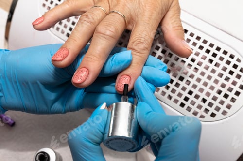 Preview: Closeup of Manicure Process with Gloves and Nail Polish