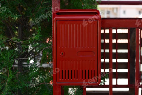 Preview: Red beautiful metal letter box near tree outdoors
