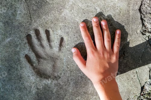 Preview: Childs hand and memorable handprint in concrete