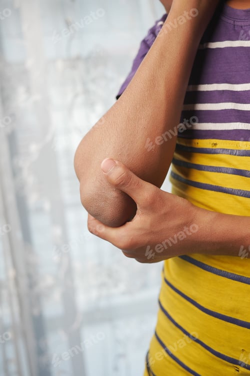 Preview: young man suffering pain on elbow