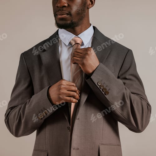 Preview: African man adjusting tie, business attire studio shoot