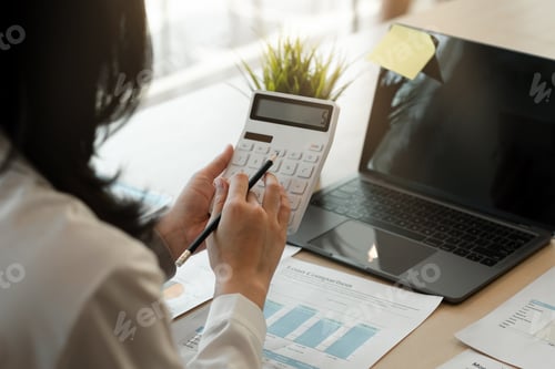 Preview: businesswoman working on desk office with using a calculator to calculate the numbers, finance