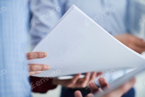 Preview: Cropped view of colleagues holding paperwork