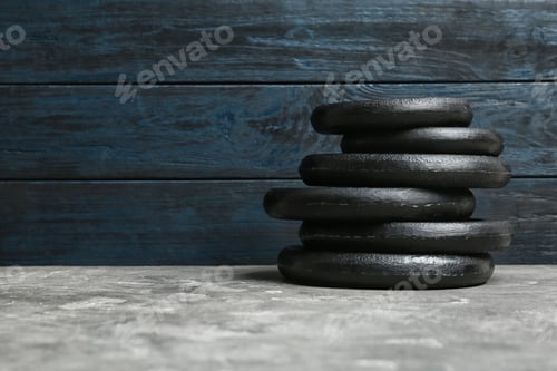 Preview: Composition of dumbbell plates on floor. Space for text