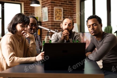 Preview: Diverse friends watching crime movie on laptop