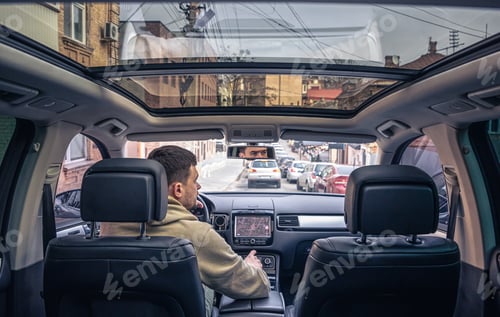 Preview: A male driver drives at speed through the streets of the city.