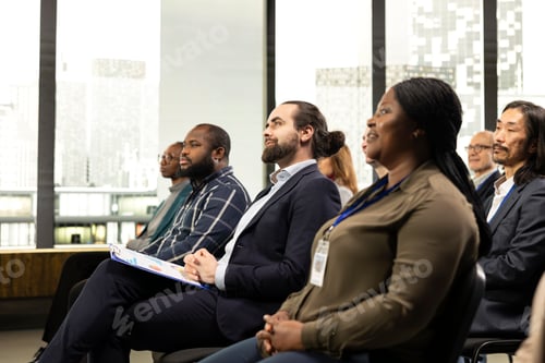 Preview: Business conference talk in auditorium with diverse audience members on chairs
