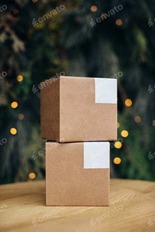 Preview: Mockup. Kraft paper boxes with white stickers on Christmas background.