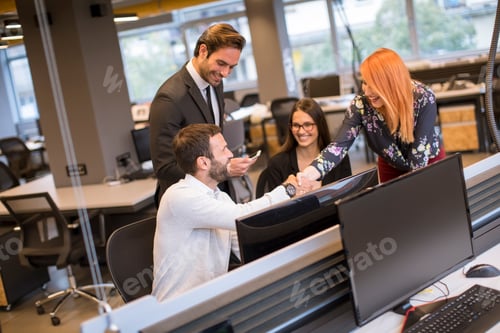 Preview: Young business people shaking hands in the office