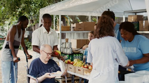 Preview: Wheelchair-bound man receives food