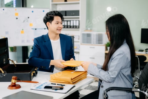 Preview: justice and law concept.passing bribe money in the envelop at lawyer office.