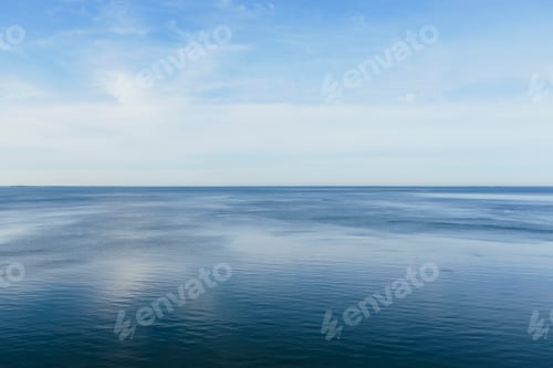 Preview: View out to the open sea from the coast. Flat calm water surface.