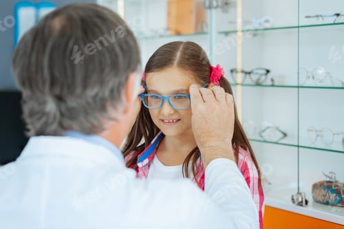 Preview: Pleasant cute girl trying on new glasses