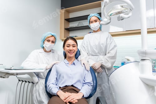 Preview: Portrait of Asian young woman patient and dentist workers in the clinic.