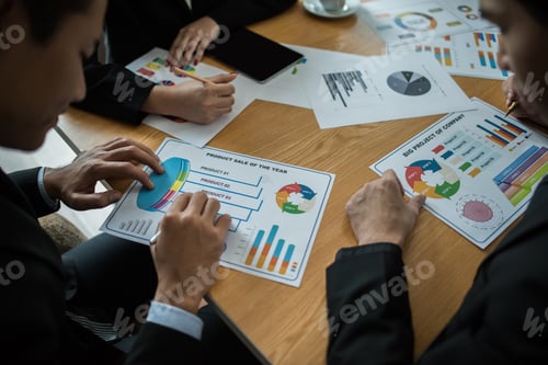 Preview: Close up of business people working with business document during discussion at meeting.