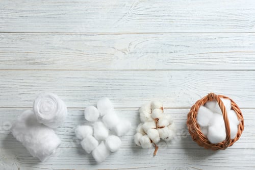 Preview: Flat lay composition with cotton balls, rolls, flowers and space for text on white wooden background