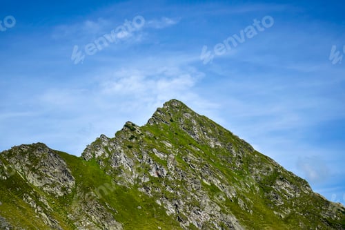 Preview: Mountain landscape, peak of mountain range. Close-up. Top of mountain range against cloudy sky