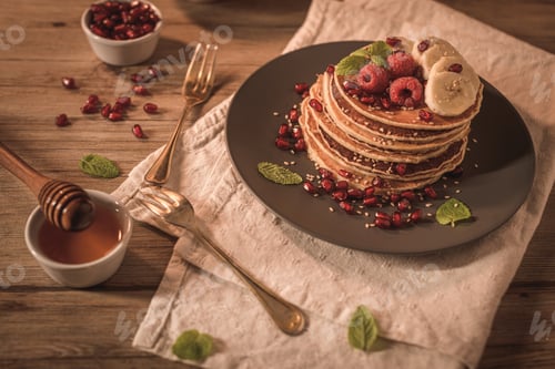 Preview: Pancakes Stacked with Raspberries, Bananas, and Pomegranates