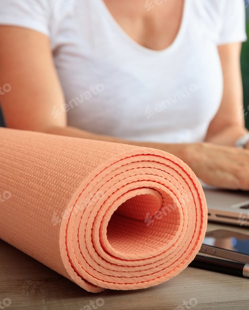 Preview: Woman and an exercise mat in an office background