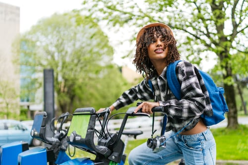 Preview: Young hispanic latina student renting a bike sharing service