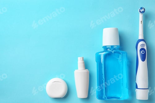 Preview: Flat lay composition with electric toothbrush and oral hygiene products on color background