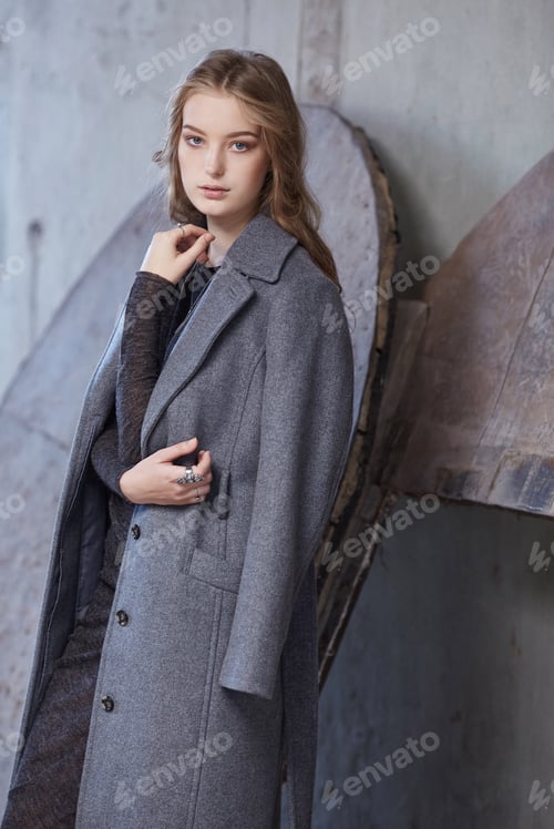 Preview: A woman in a grey spring coat.