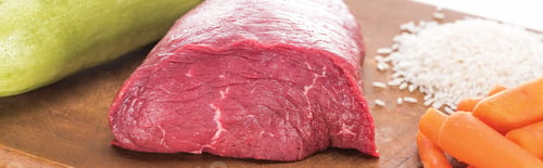 Preview: close up view of raw meat, rice, carrot and zucchini on wooden cutting board, panoramic shot